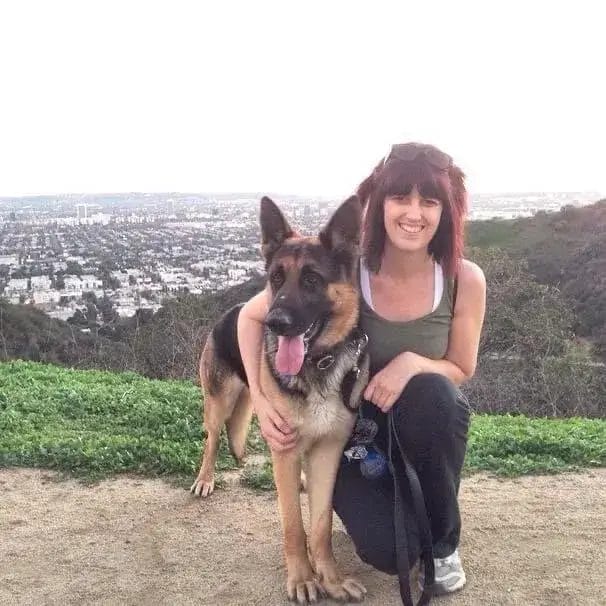 Woman and German Shepherd dog on Runyon Canyon off leash hiking trail.