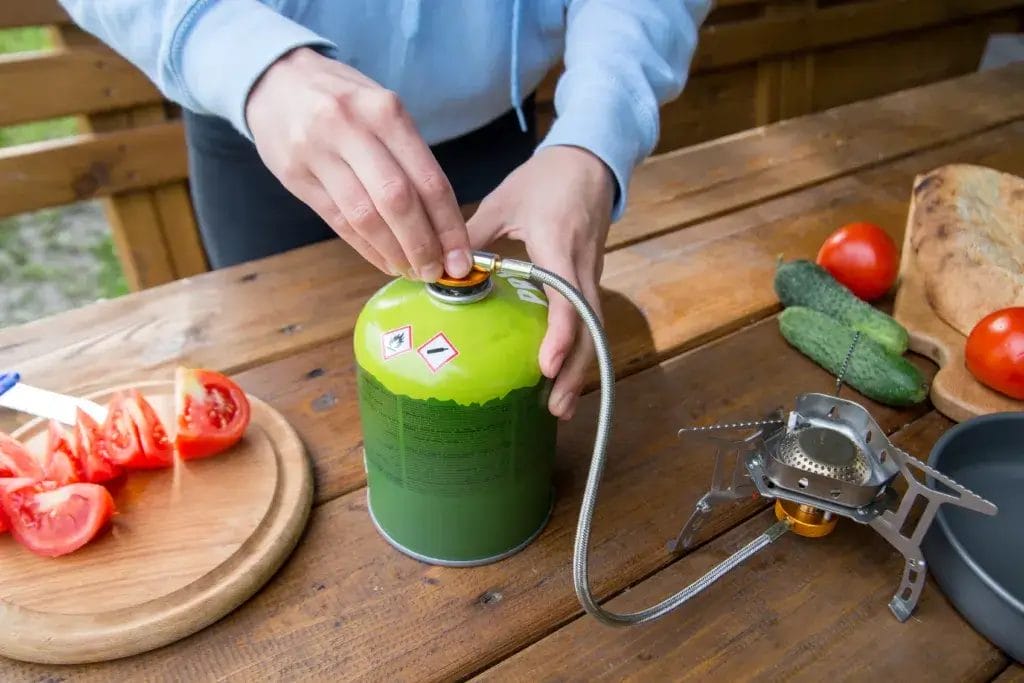 The process of using a gas tourist cylinder for cooking.