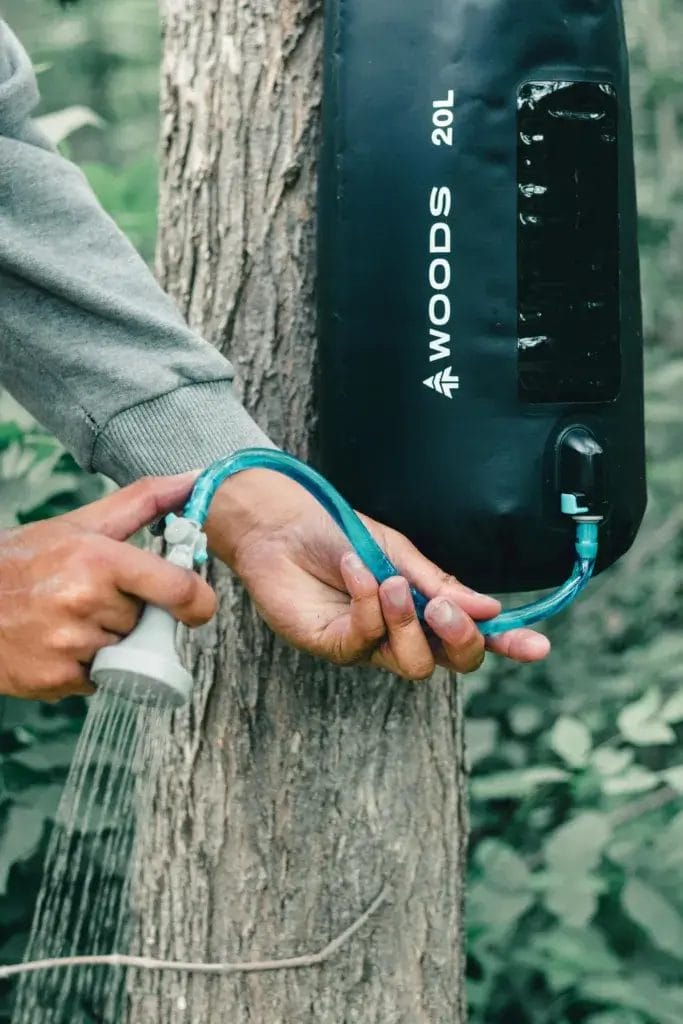 Solar camping shower with shower head attachment.