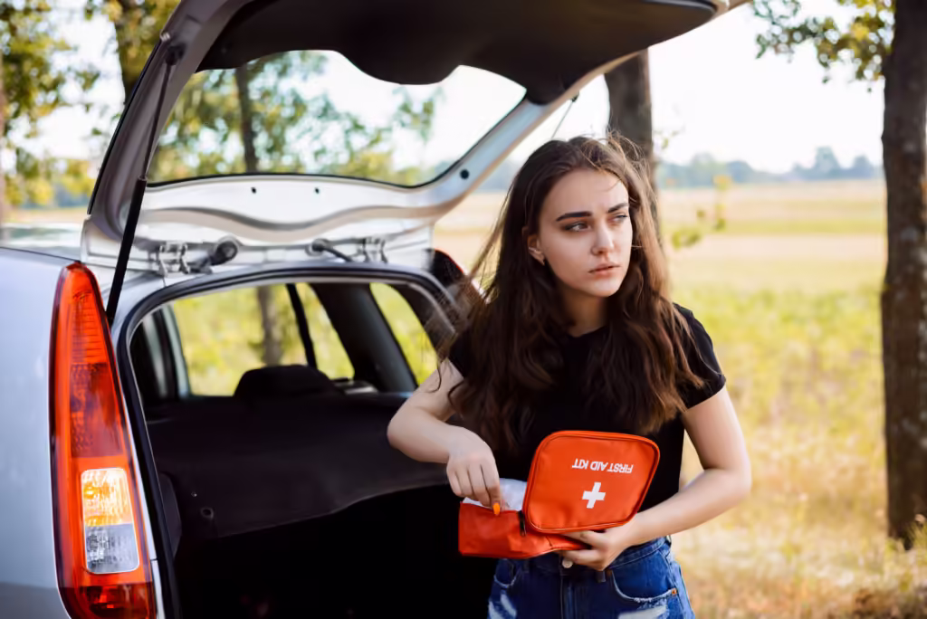 Young girl is in a hurry to give first aid to victim of car accident in countryside.
