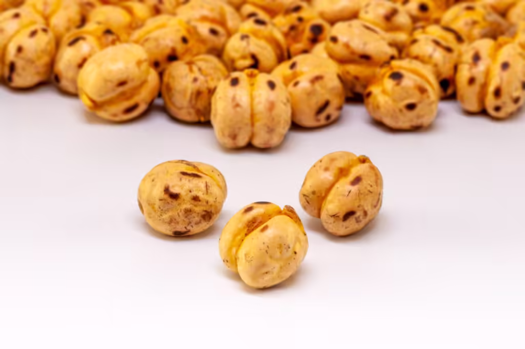 Roasted chickpeas macro shot on white. Focus on foreground.