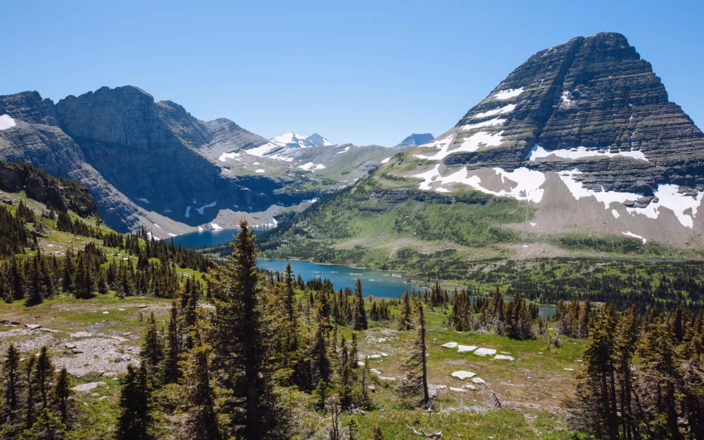 Snowy mountains with a river running through at Glacier National park.