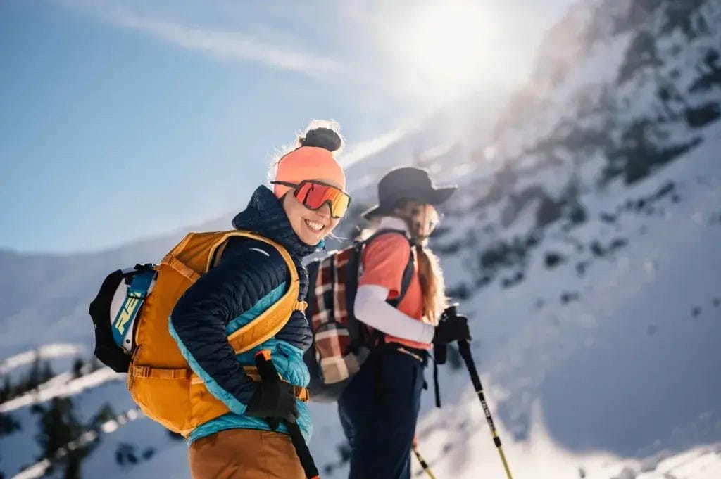 Two women hiking in the snow.