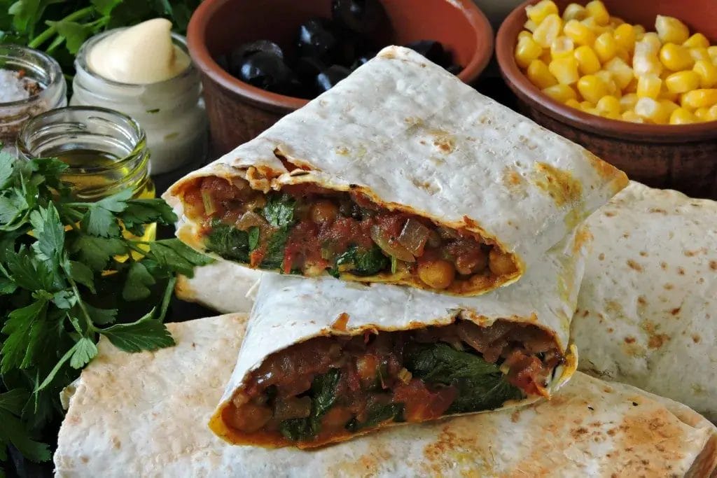 Spicy black bean burrito cut in half.