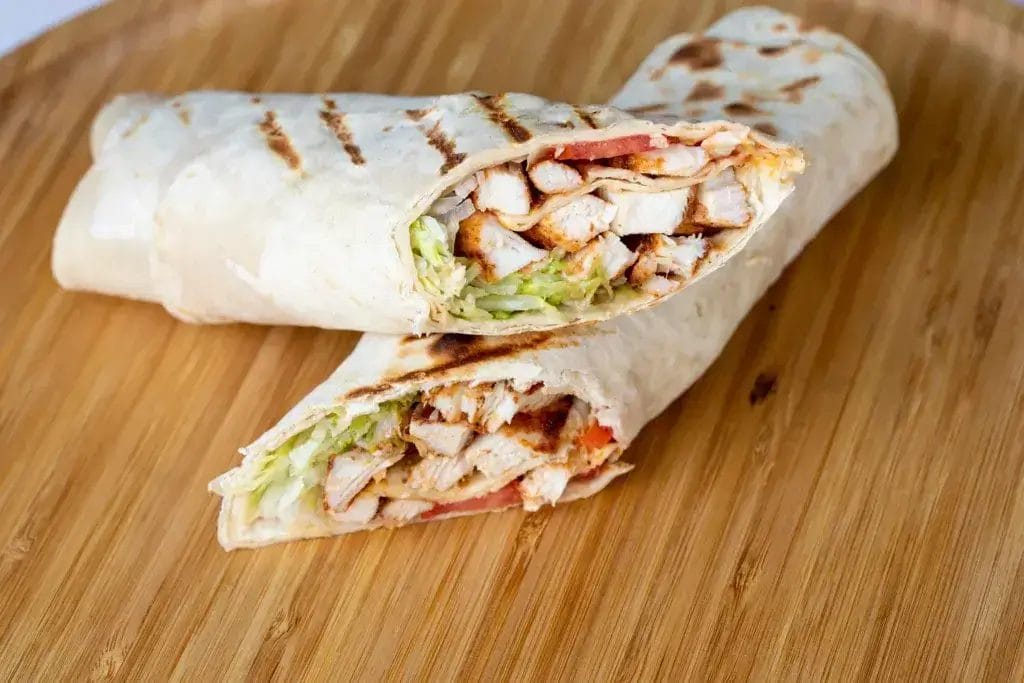 Chicken Waldorf salad wrap cut in half.
