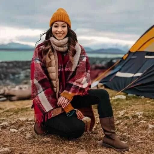 Ethnic Woman wearing cute trendy camping outfits including stylish parka or puffer jacket, stylish waterproof boots, colorful beanie, patterned scarves. Include a leather-strapped watch and a rustic backpack.