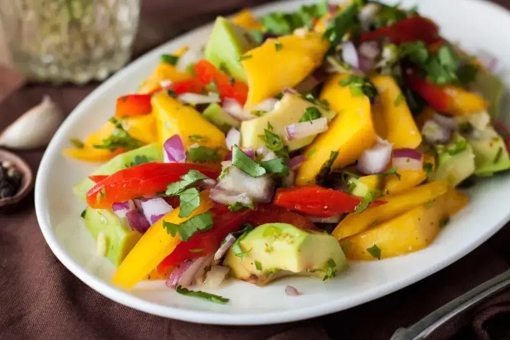 Mango and avocado salad on a plate.