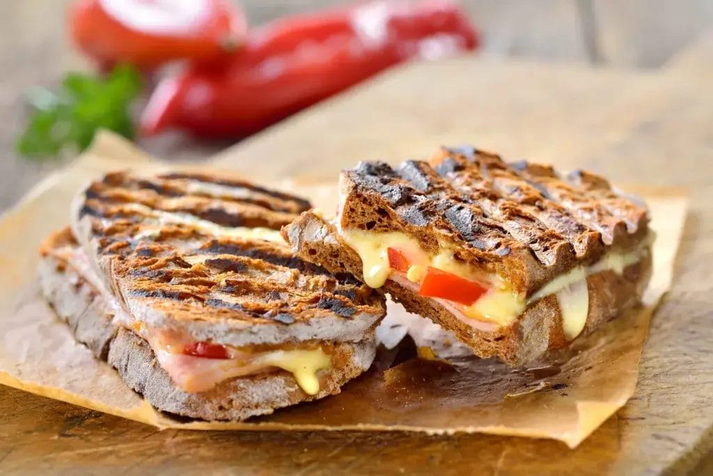 Smoked turkey and brie sandwich cut in half.