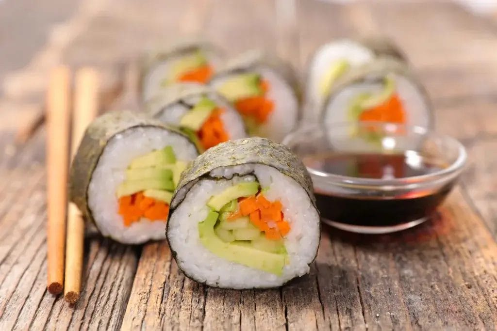 Vegetable sushi rolls with soy sauce.