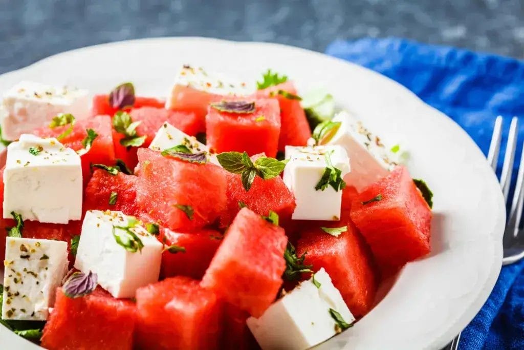 Feta and watermelon salad on a white plate.