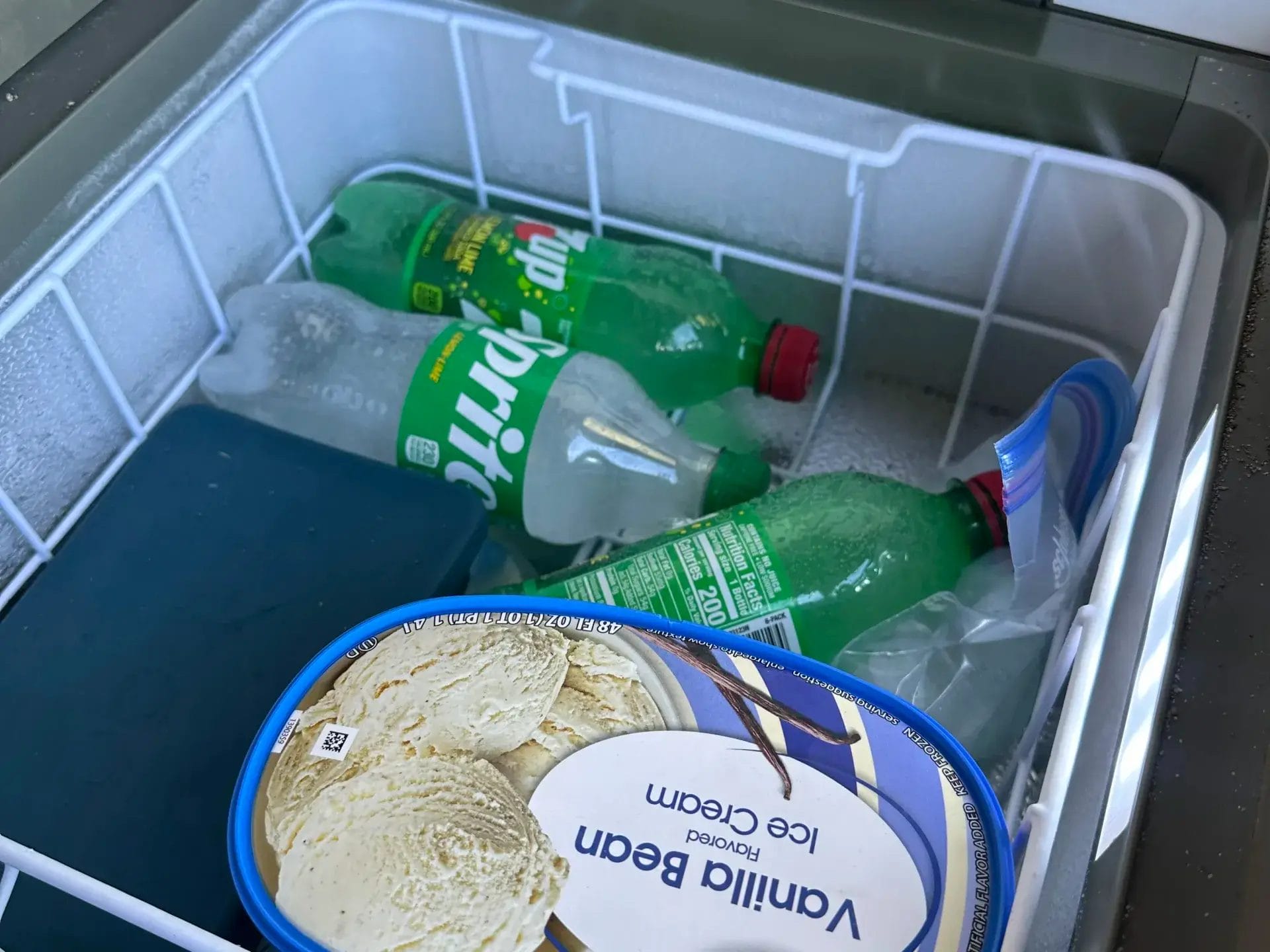 Iceco freezer with ice cream, frozen water and ice cubes.