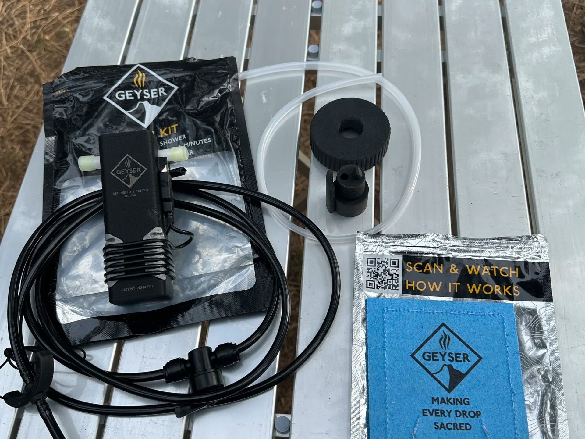 Geyser Clean Kit components sitting on a silver camp table.