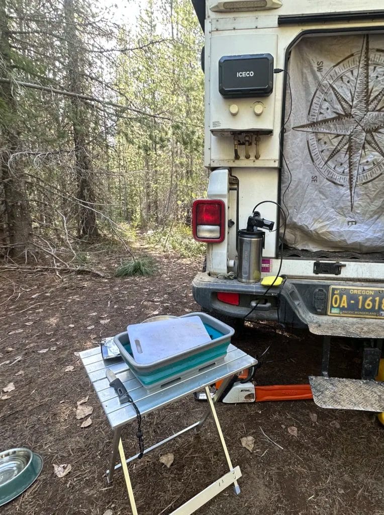Camp scene with Geyser Clean Kit being used to wash dishes.