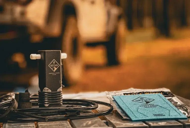 Geyser Clean Kit sitting on a table with a Jeep Gladiator in the background.