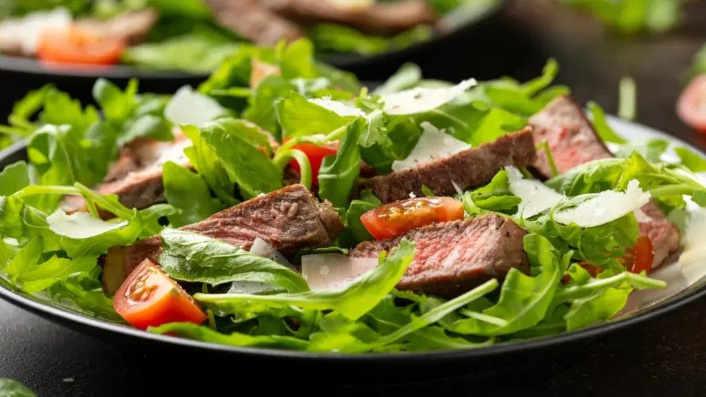 Italian Beef Tagliata salad with wild rocket, cherry tomatoes and parmesan cheese.
