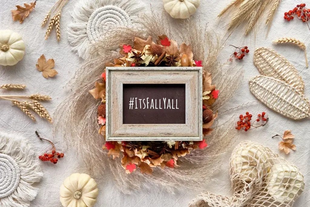 Autumn decorations on a table with a sign that says #itsfallyall