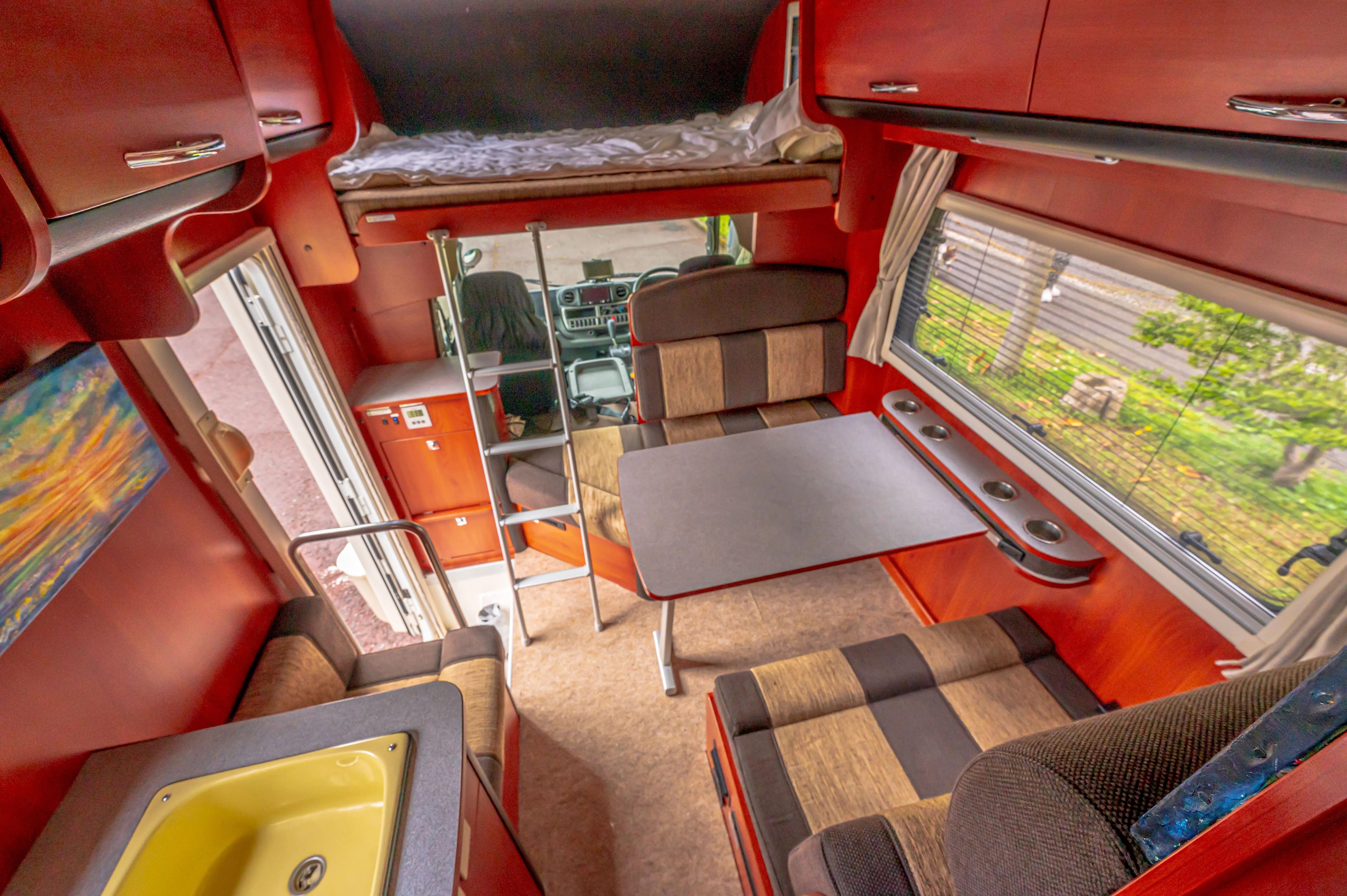 Interior of a camper van with colorful orange walls.